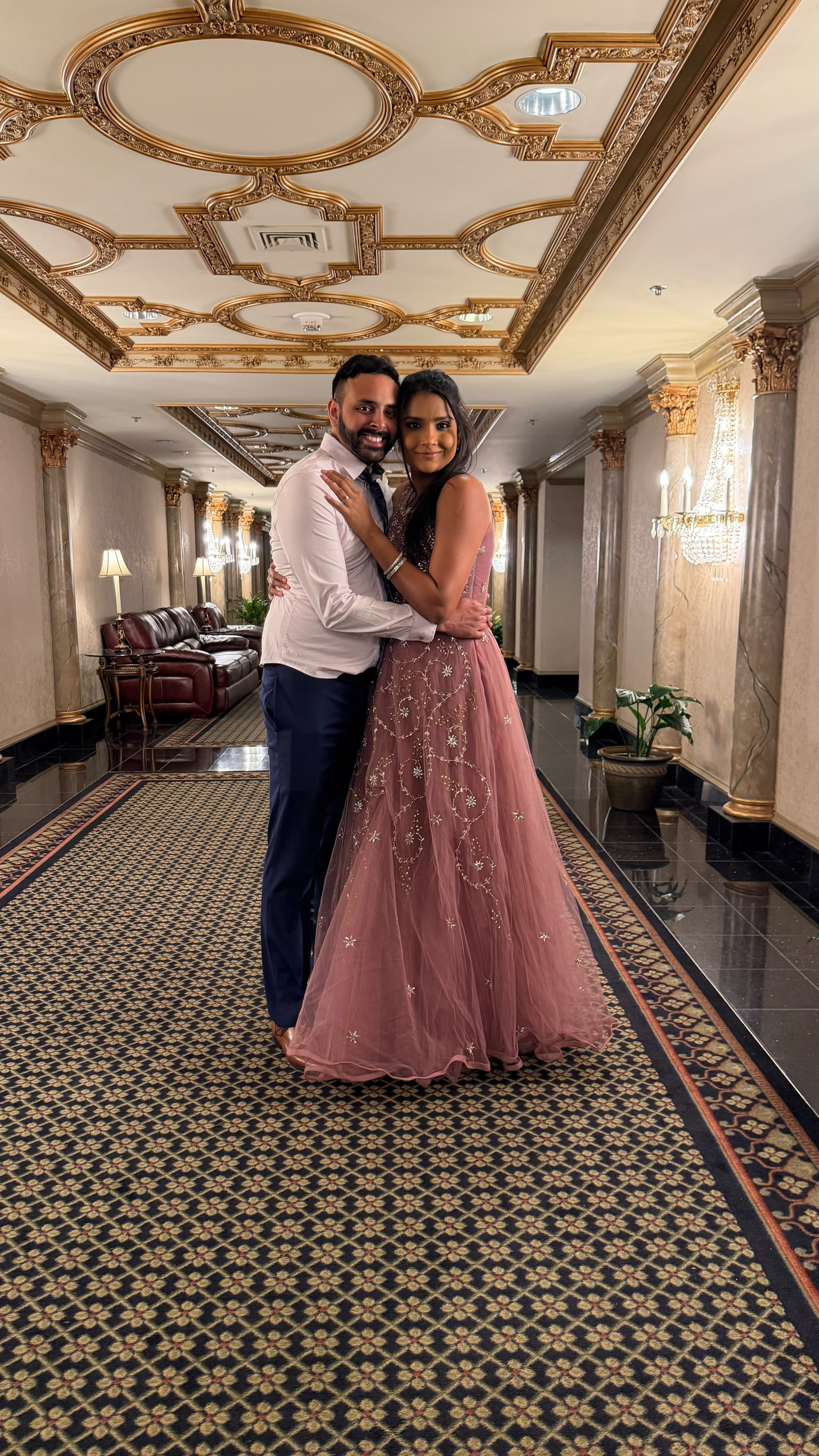 Kareena and Arvin embracing in an ornate hallway