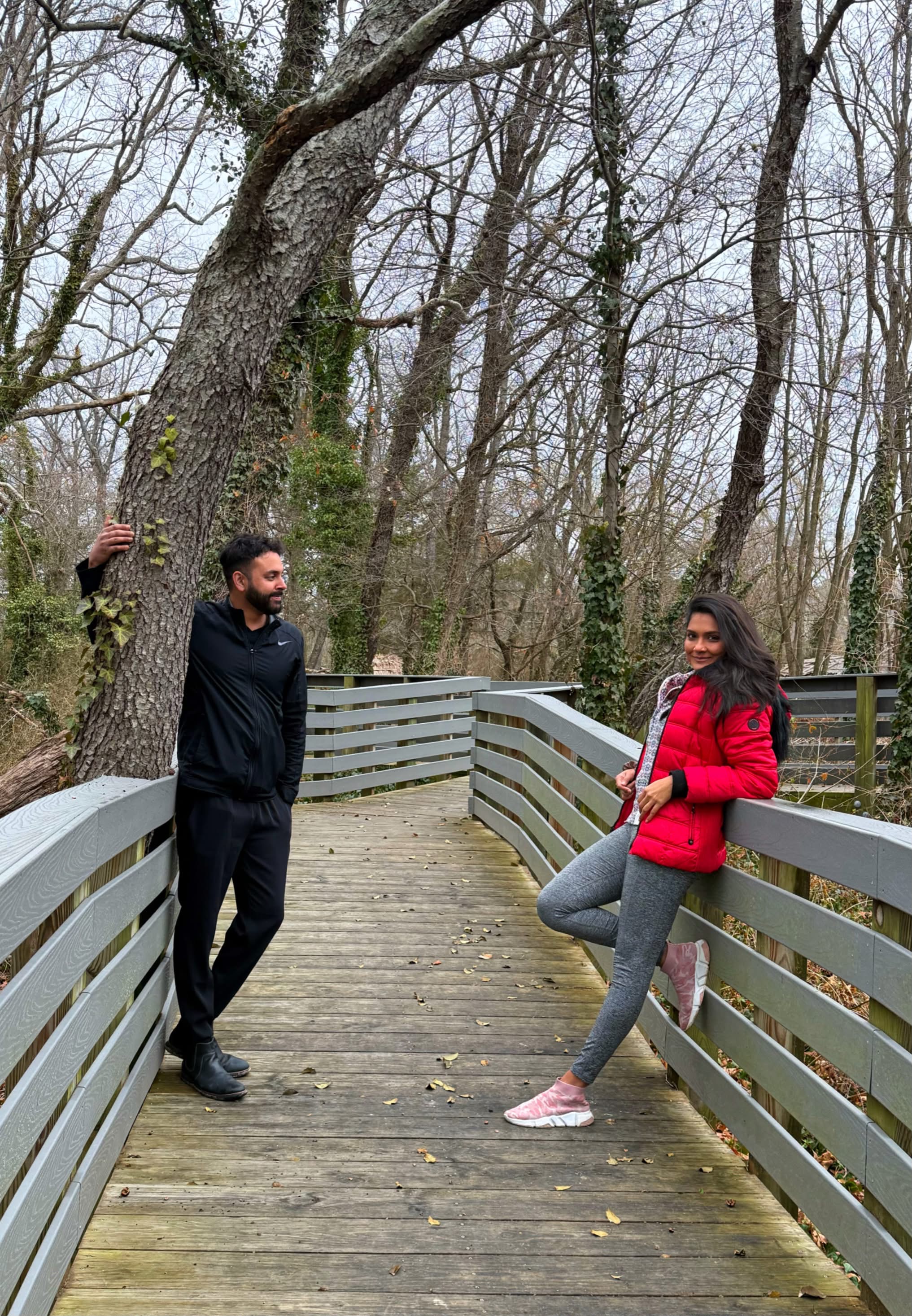 Kareena and Arvin on a wooded boardwalk in winter