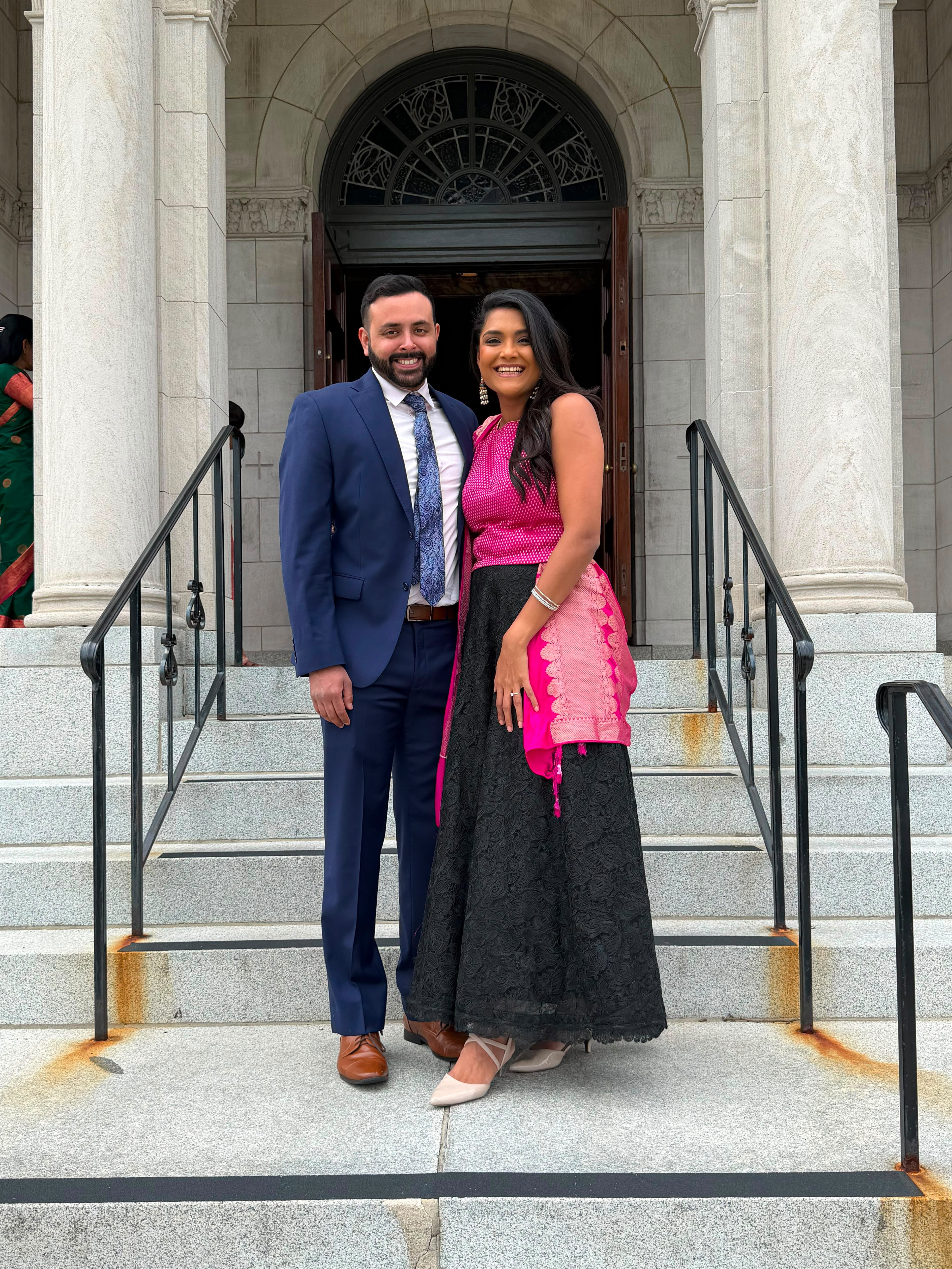 Kareena and Arvin dressed up on the steps of a church